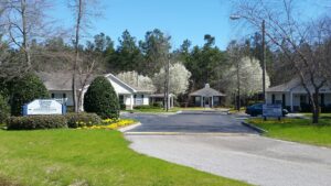 An entrance to an apartment community with trees