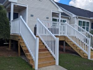 A new white railing that leads to a one story apartment building