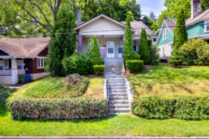 House with multiple apartments inside. Stairs leading from the street to front door.