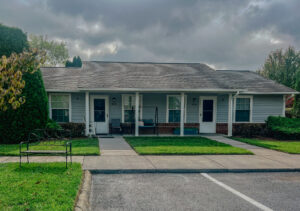 Single story apartment building with porch