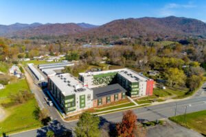 Ariel view of apartment complex and mountains, trees