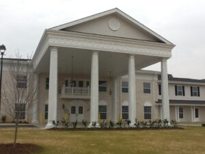 A large two story carport area on the front of a building