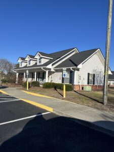 A one story building with a blue sky