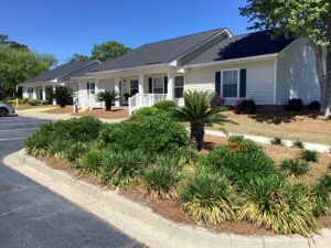 A one story apartment building with landscaping