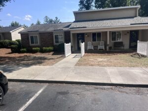 A one story building with a sidewalk