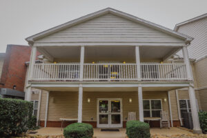 A two story apartment building with a balcony