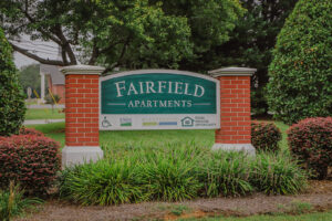 A brick apartment sign