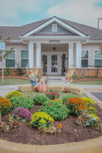 Apartment Complex front office with flower bed and fall decorations