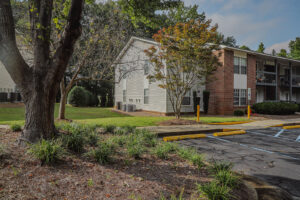 A two story apartment building with green landscaping