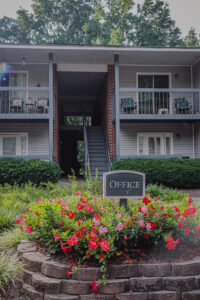 A two story apartment building with flowers