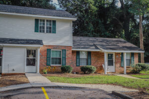 A split level apartment level with a green yard