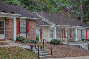 A pair of one story apartment buildings with stairs