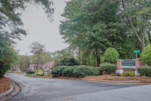 The entrance to an apartment community with greenary