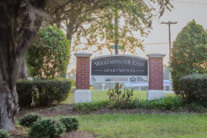 A brick entrance sign to Westminster East Apartments