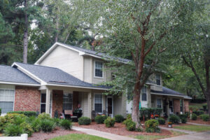 A two story apartment building with trees