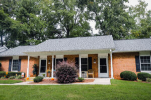 A one story brick apartment building with green grass