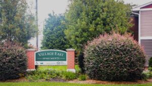 Village East apartment complex sign