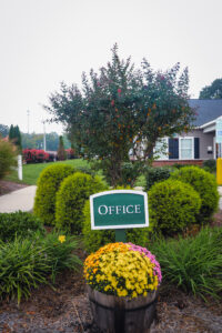 Apartment complex front office sign and landscaping