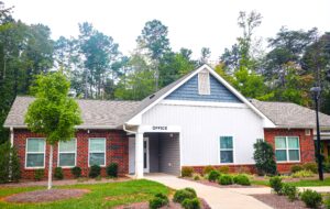 Single story brick building with siding