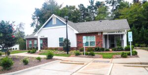 Single story brick building with siding