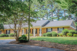 Single story apartments with yard and trees