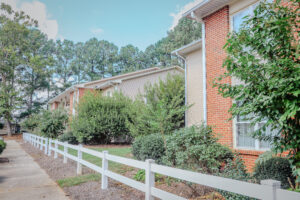 Two story building with fence and landscaping