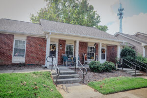 Brick one story building with covered porch