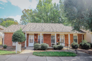 Brick one story building with covered porch