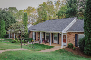 Single story brick apartment building with covered porch