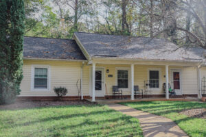 Single story apartment building with covered porch