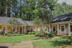 Single story apartment building with covered porch