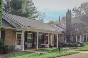 Single story brick apartment building with covered porch