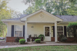 Single story apartment buildings with covered porch