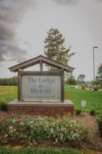 The Lodge at Hickey apartment complex sign with landscaping