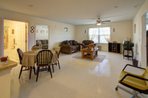 Community room with large window and ceiling fan