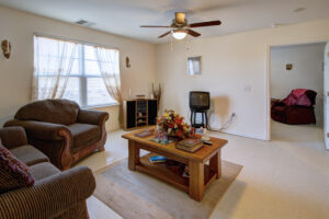 Living space with large window and ceiling fan