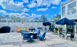 Community outdoor area with seating, grill and flowers