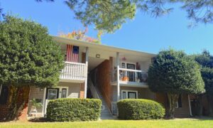 Two story apartment complex with mature landscaping