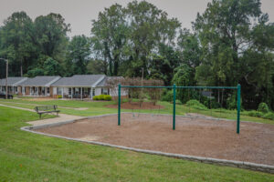 A one story apartment building with a play ground