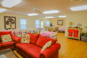 Community room with couches, table, and chairs