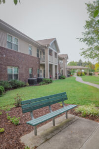 Two story apartment complex with bench