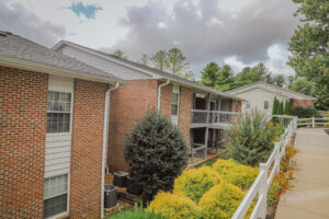 Two story apartment complex with paved walkways and landscaping