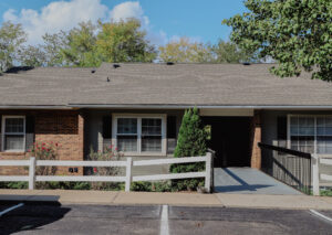 Two story apartment complex with walkway front parking lot