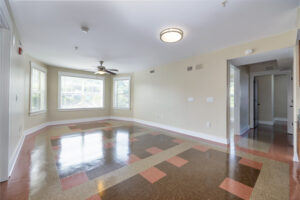 Large room with tile floor and ceiling fan