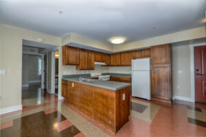 Kitchen with tile floor and brown cabinets