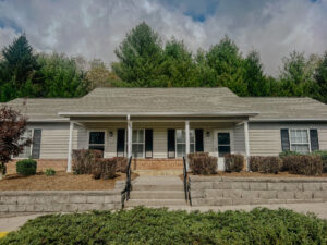 Single story apartment with front porch and steps leading to front door