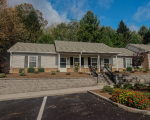 Single story apartment complex with front porch and steps