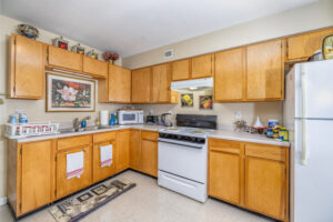 Kitchen with brown cabinets and white appliances