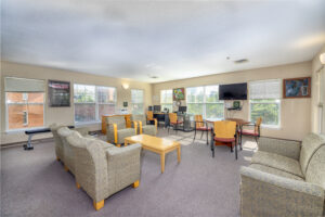 Community room with TV, couches and chairs