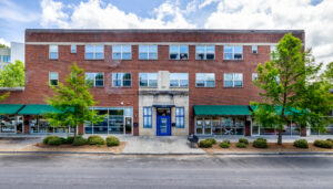 Brick building with shops on ground floor and apartments on the second and third floor